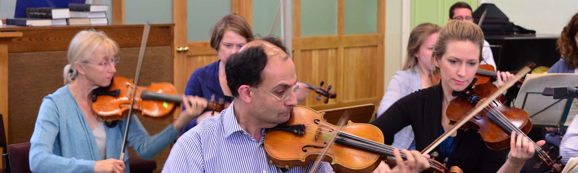 FSO first violins in rehearsal